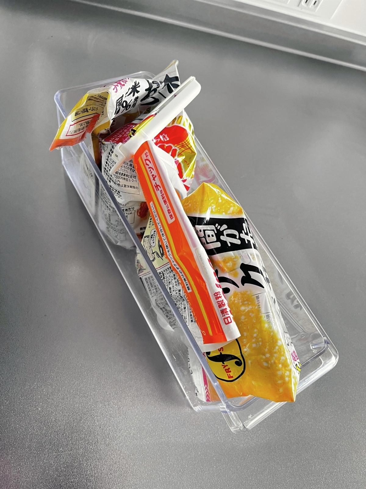 A slim clear case holding bags of tempura batter mix and other flours