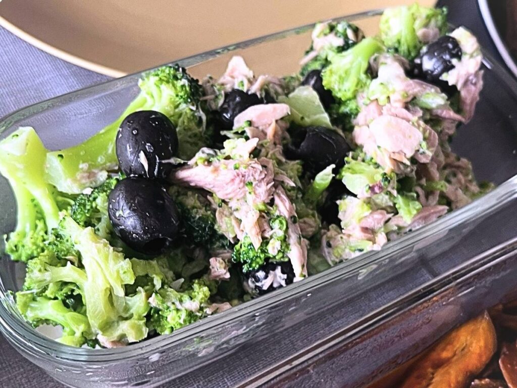 Broccoli, tuna and black olive salad in a glass container