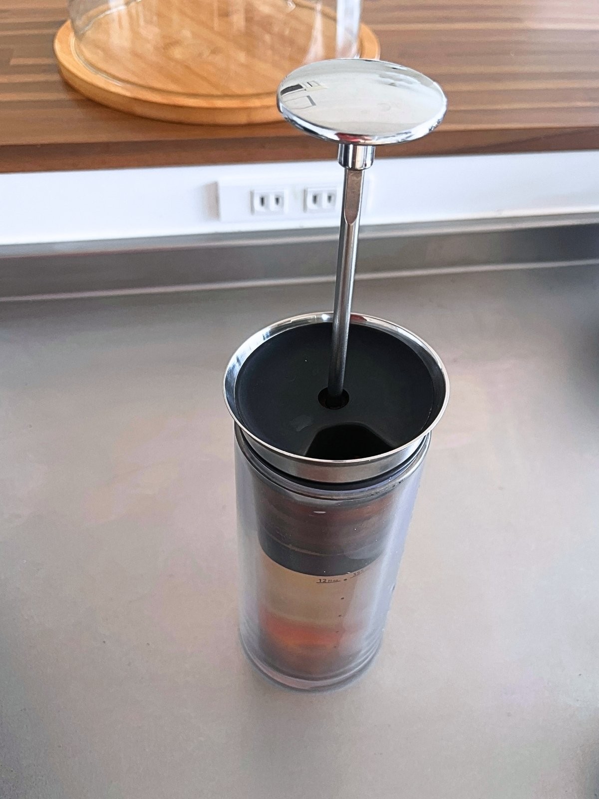 The American Press plunger and pod set in the carafe, before pressing