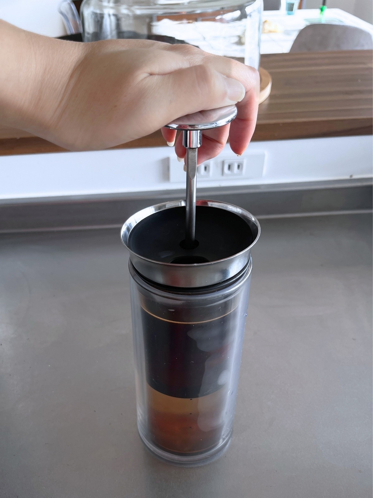 Pressing the American Press plunger down by hand