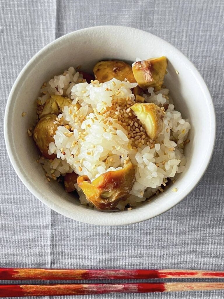 Chestnut rice in a white rice bowl with chopsticks