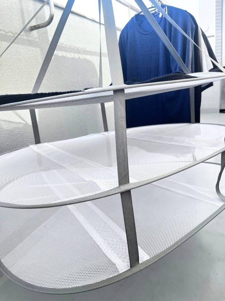 The lower tiers of a 3-tier hanging mesh drying rack